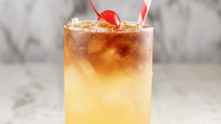 Pineapple Rum Punch with cherry and straw
