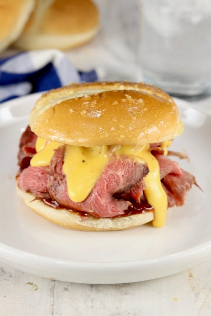 Roast Beef Sandwich with cheddar sauce on a white plate