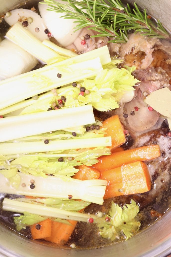 Stock pot with vegetables and turkey carcass for broth