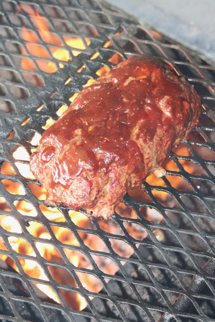 Meatloaf on a grill brushed with BBQ sauce