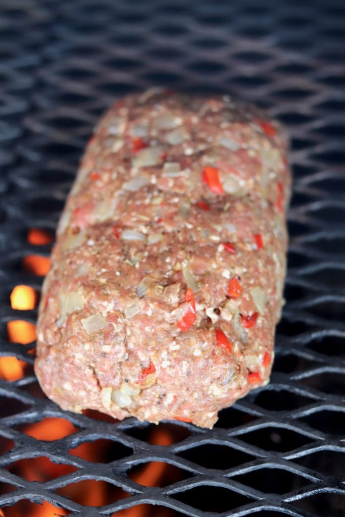 Meatloaf with peppers and onions on grill