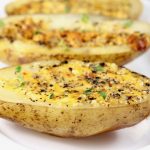 Baked potato halves with cheese and bagel seasoning
