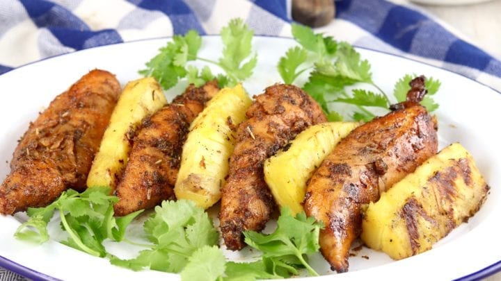 Grilled Marinated Chicken with grilled pineapple on a white plate