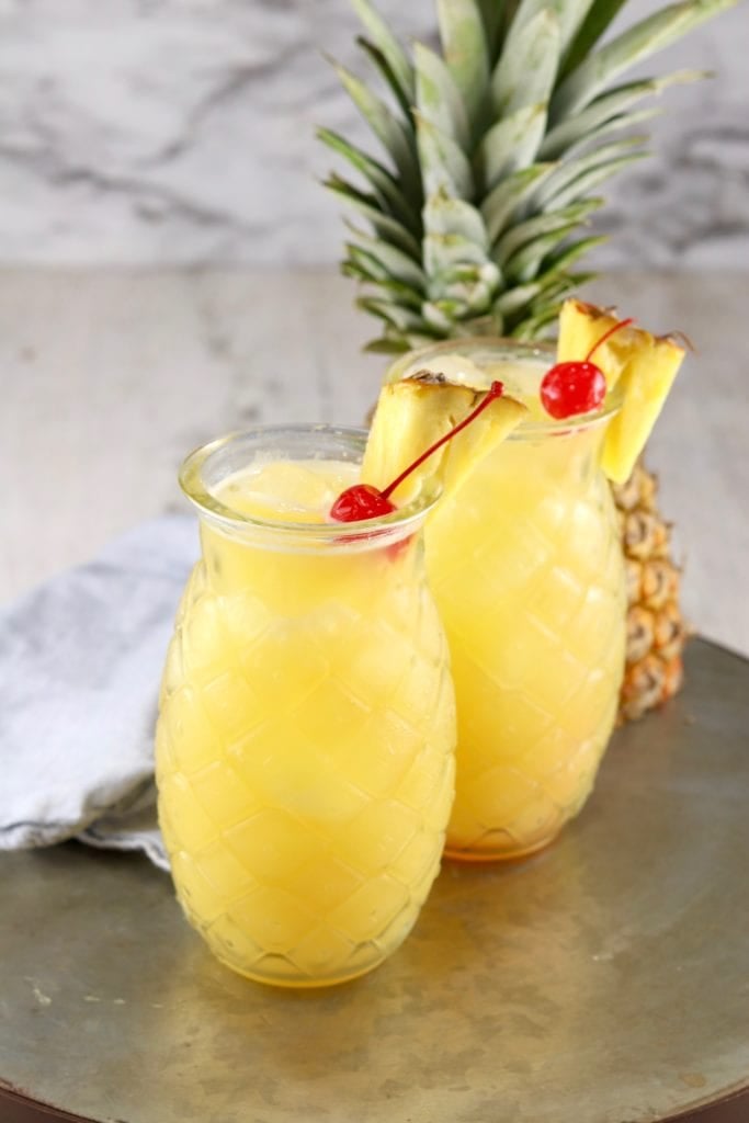 Pineapple Fuzzy Navel drink in a pineapple shaped glass