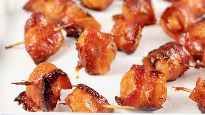 Bacon wrapped water chestnuts on a white pan