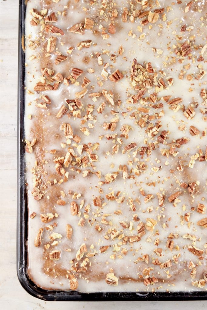 Sheet cake topped with glaze and pecans