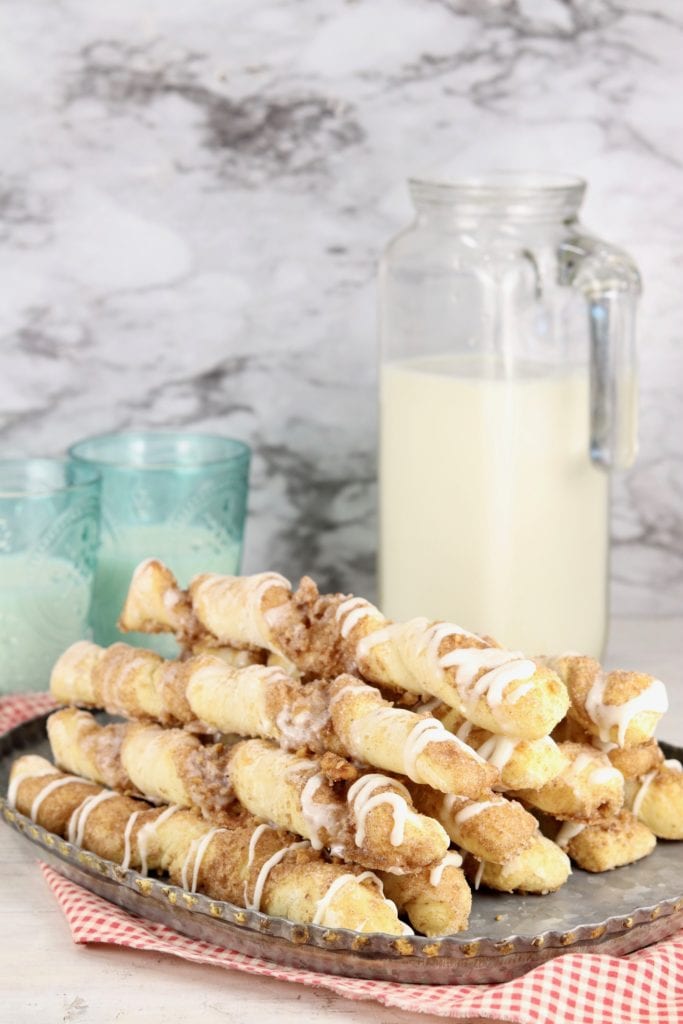 Walnut Cinnamon Twists on a platter, jug of milk and 2 glasses of milk
