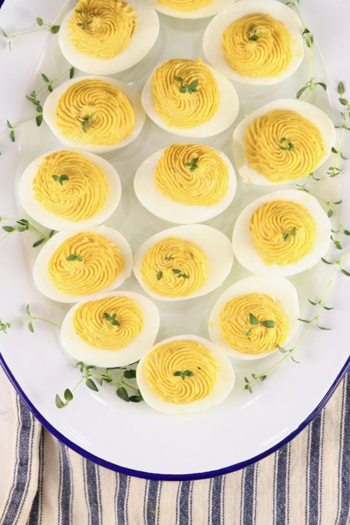 Overhead view of deviled eggs on a white plate
