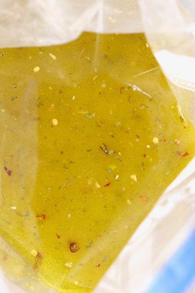 Olive oil and seasonings in a zip top bag