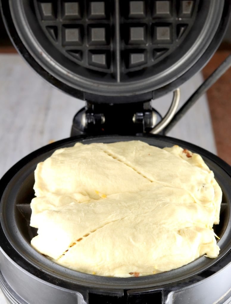 crescent stuffed dough in a waffle iron