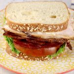 Turkey and bacon sandwich with lettuce and tomato
