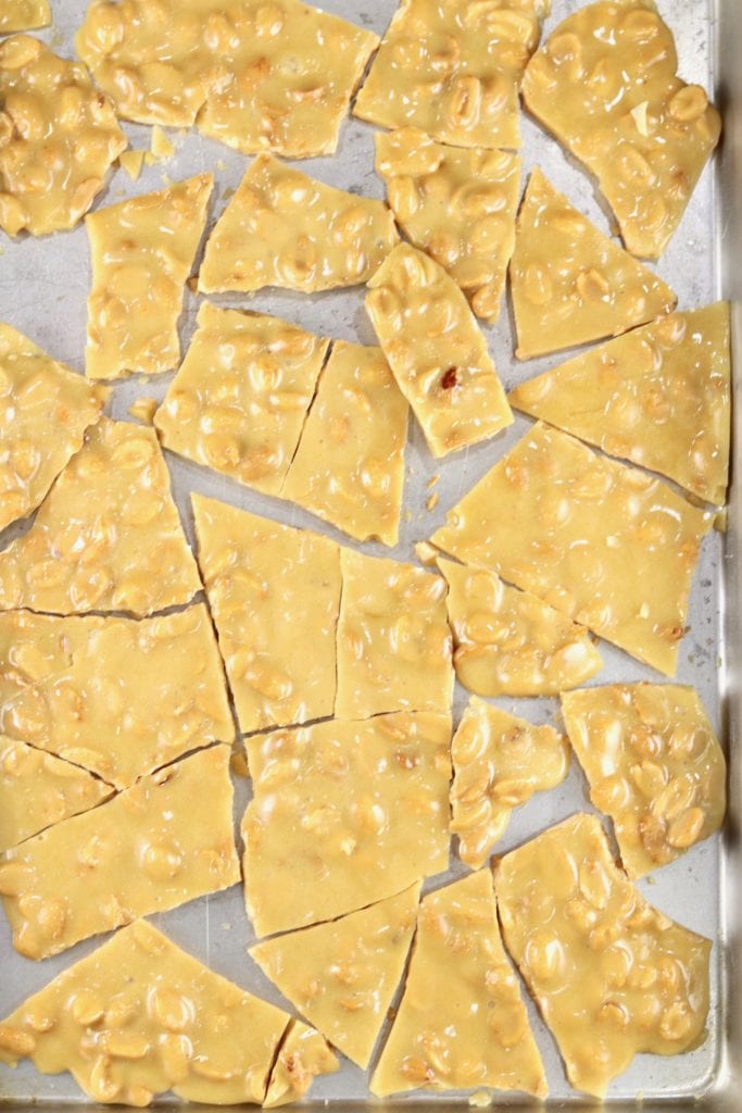 Peanut Brittle Candy broken into pieces on a sheet pan