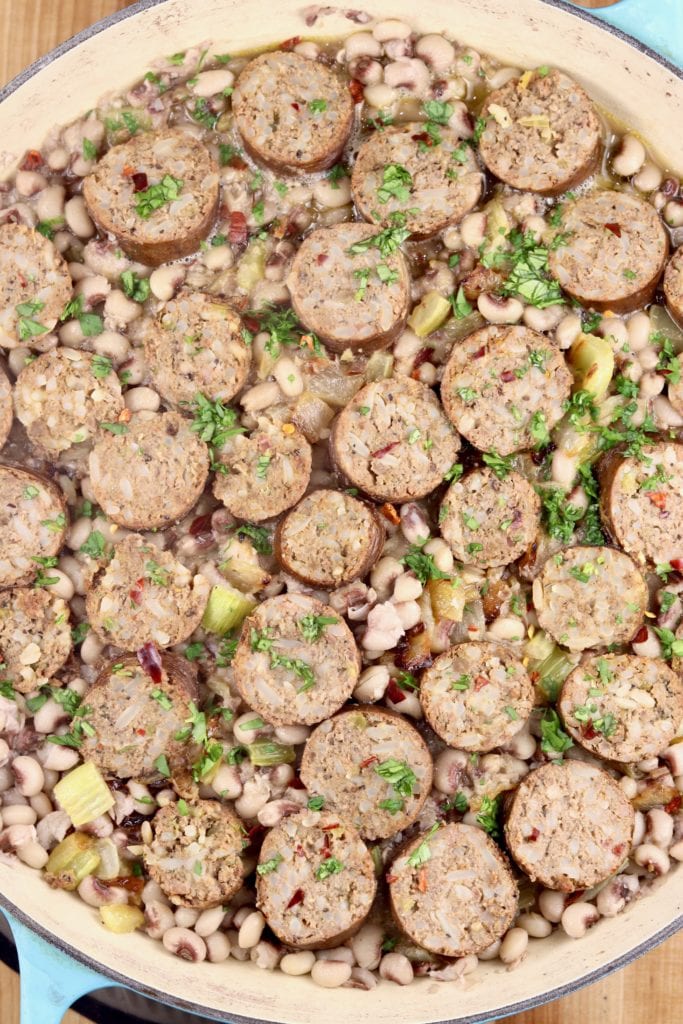 Pan of boudin and purple hull peas garnished with parsley
