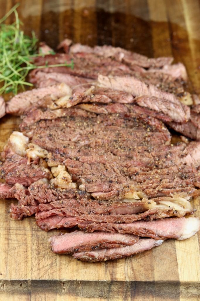 Sliced ribeye steak on a cutting board