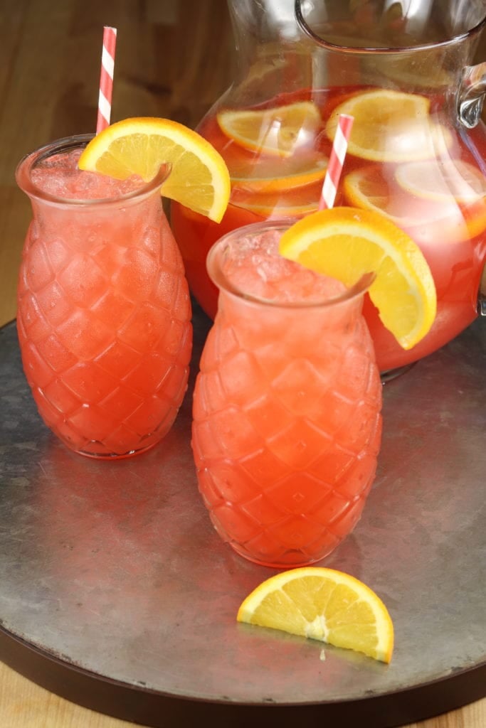 Vodka punch in pineapple glasses on a galvanized platter