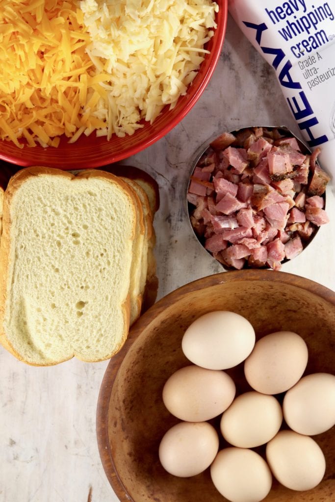 sliced bread, cheese, eggs, ham and cream for breakfast casserole