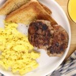 plate of scrambled eggs, sausage patties and toast