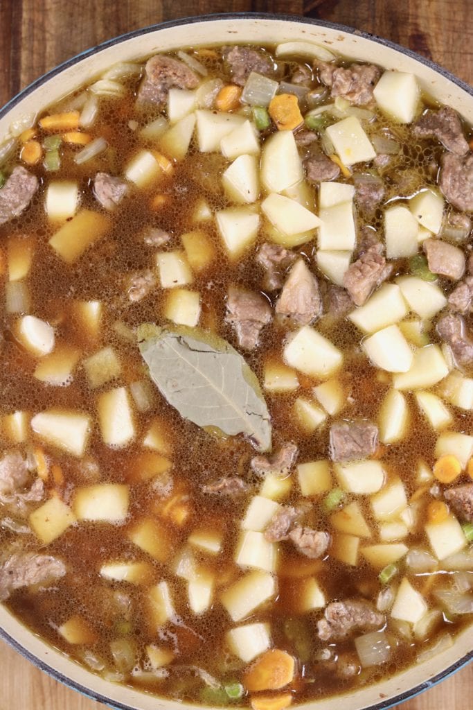 Pan of beef stew with a bay leaf