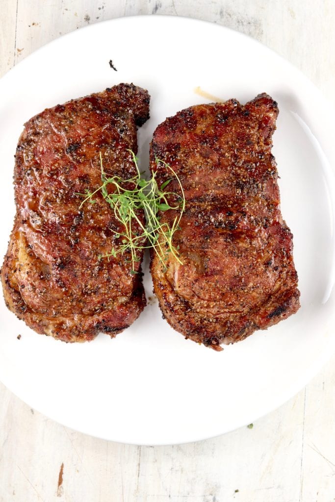 Grilled ribeye steaks on a plate