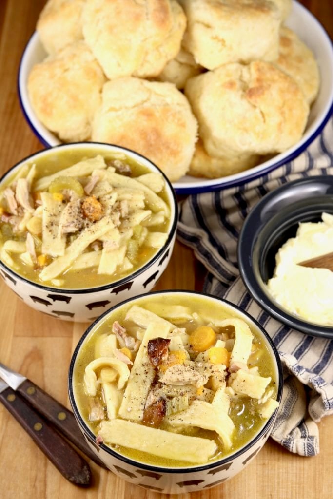 bowls of chicken soup with biscuits