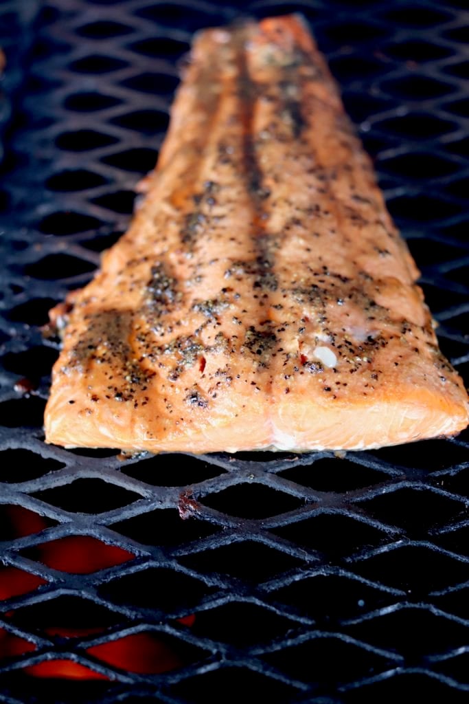 Grilling salmon over wood fired grill