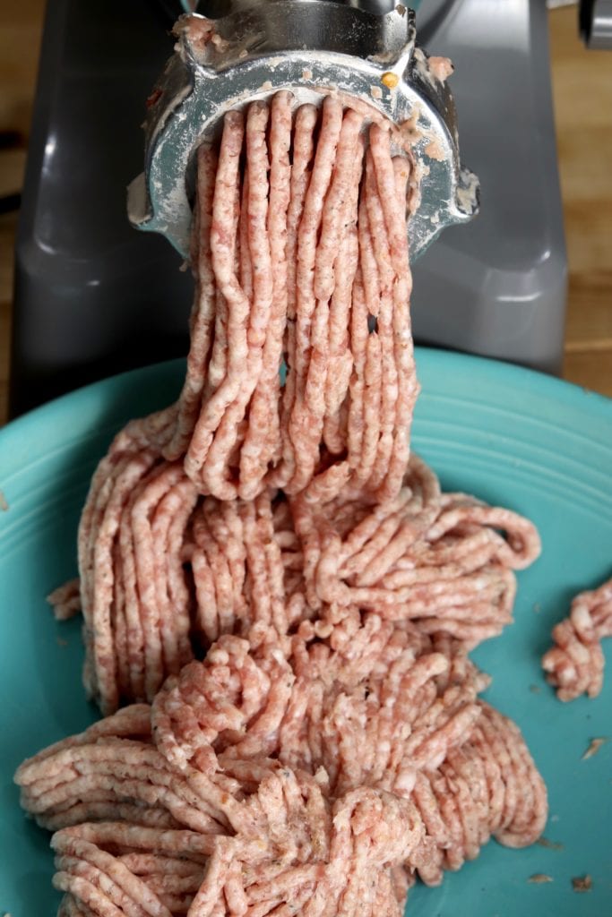 Meat grinder making pork sausage