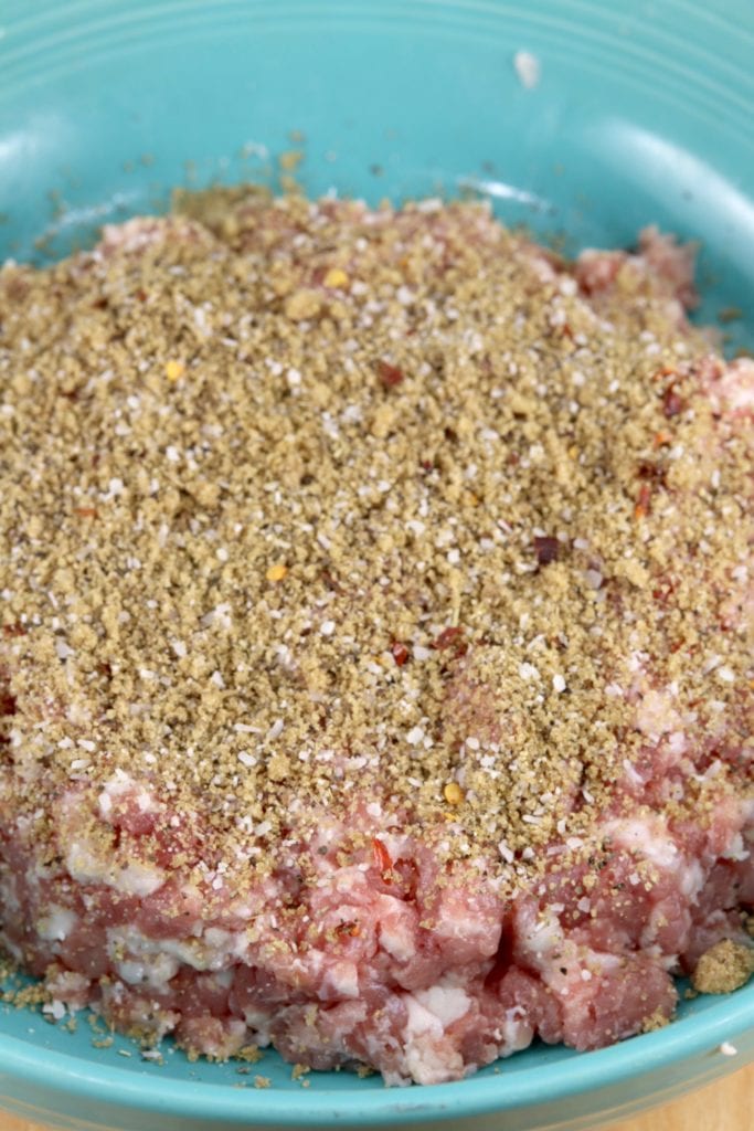 Bowl of ground pork with seasonings for sausage