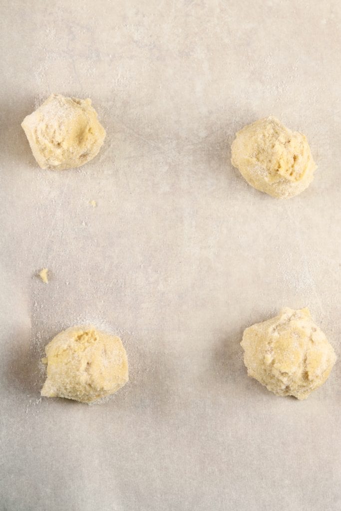 peanut butter cookie dough balls on a cookie sheet