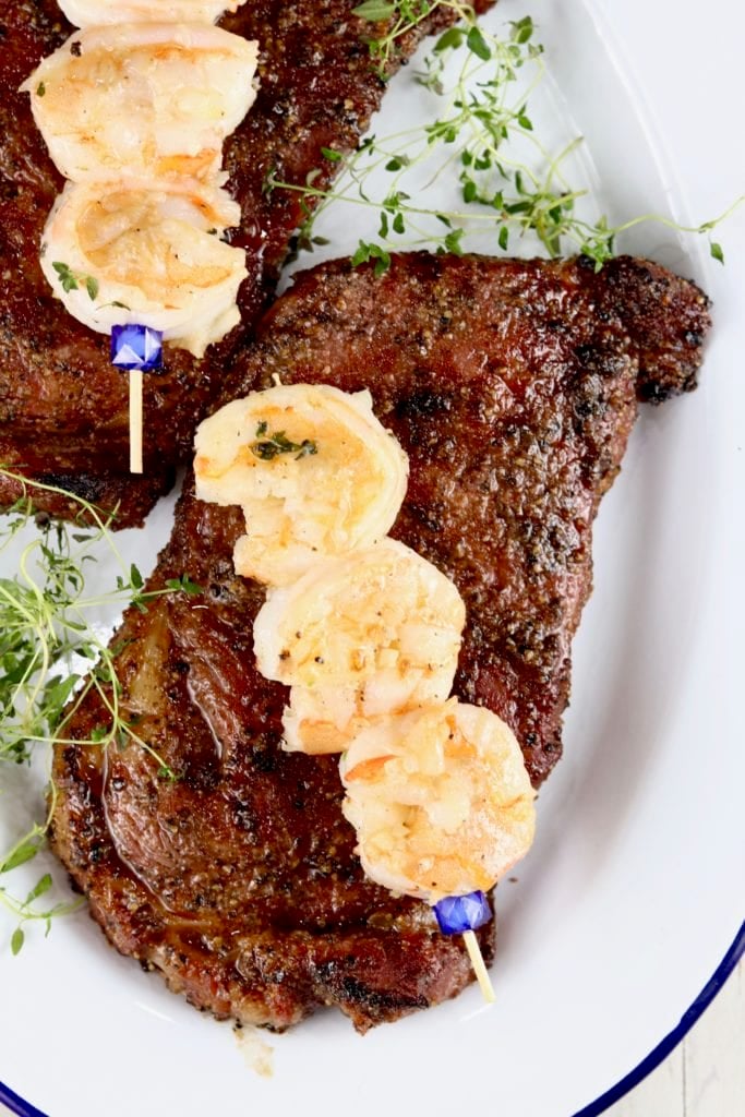 Grilled steaks topped with shrimp