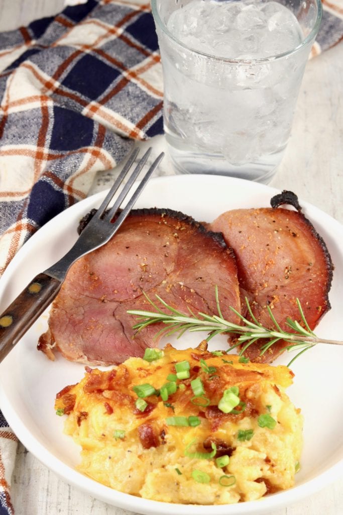 Plate of sliced ham and baked potato casserole