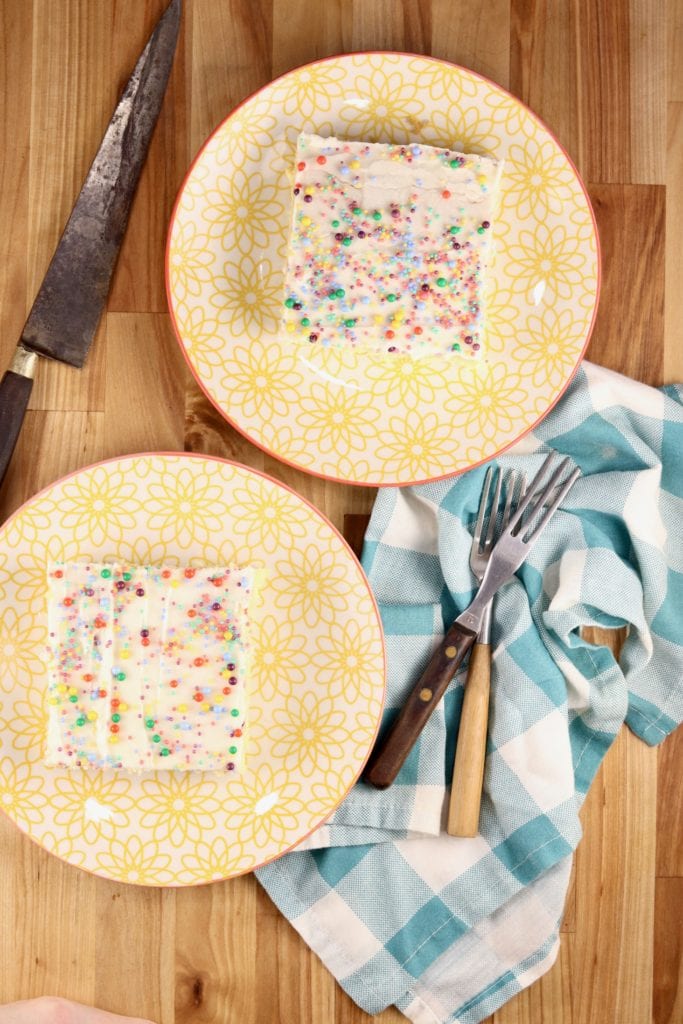 overhead view - 2 plates of slices of cake with sprinkles