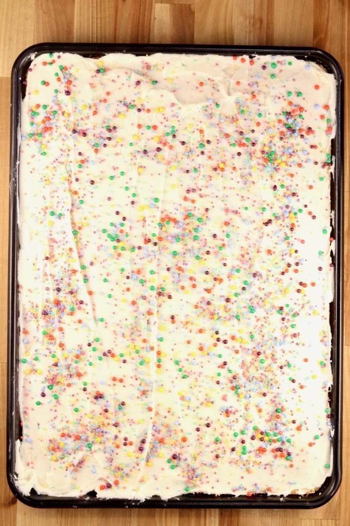 Sheet cake with powdered sugar icing and sprinkles