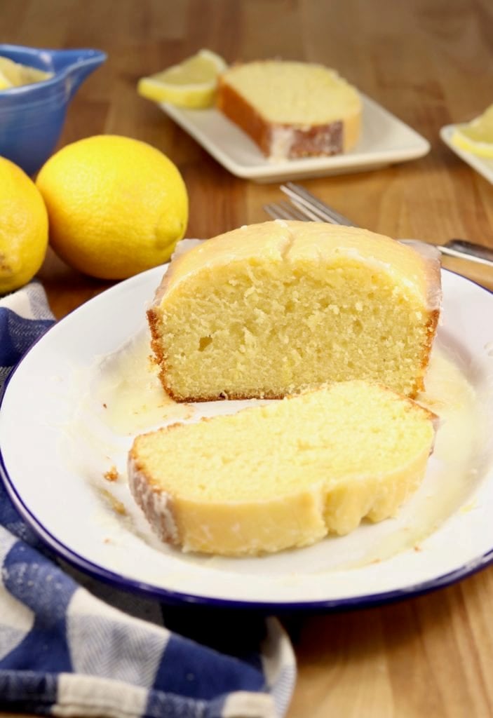 Lemon loaf cake on a platter with a slice