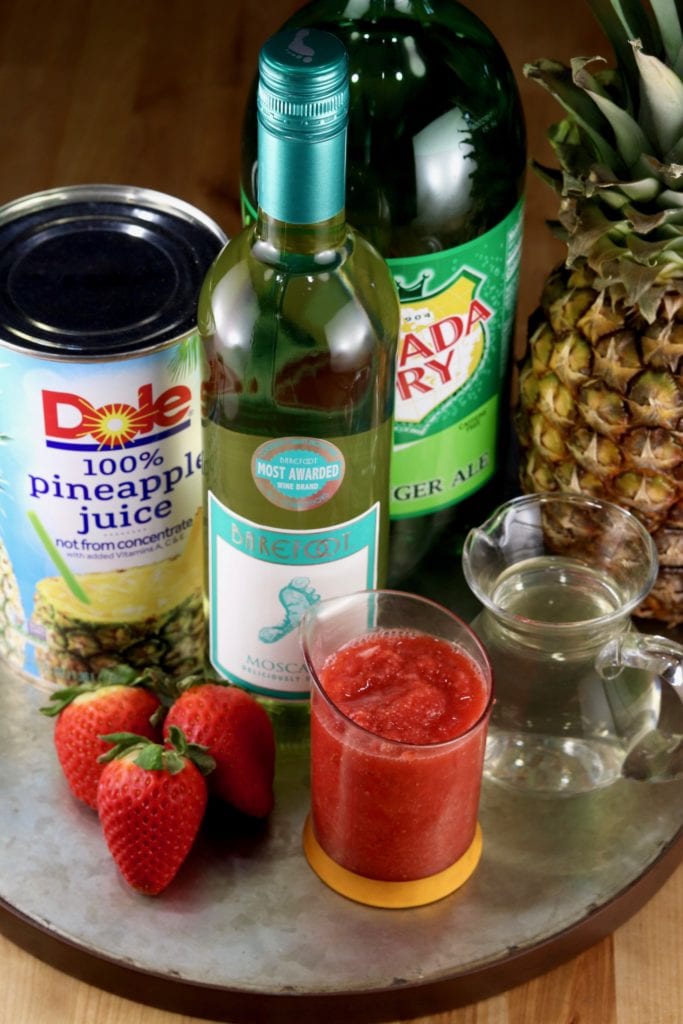wine cocktail with strawberries, pineapple juice and ginger ale