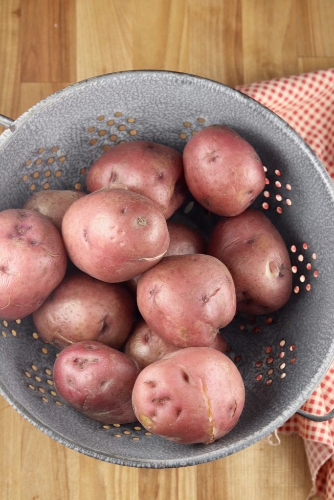 Boiled red potatoes in a colander
