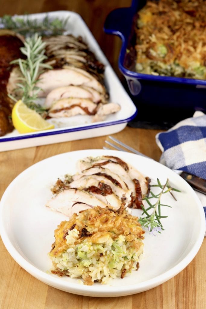 Rice and broccoli casserole plated with sliced turkey