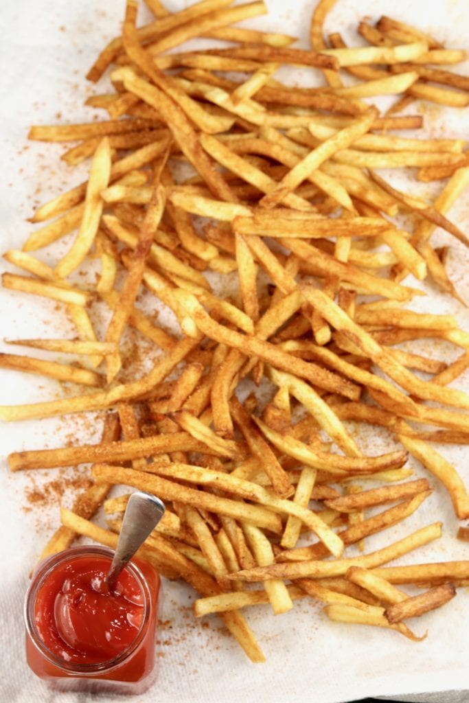 French Fries with Ketchup on a paper towel lined baking sheet