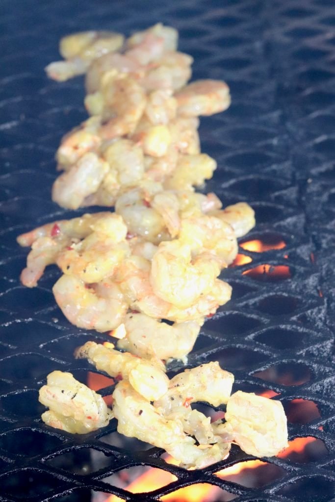 Shrimp with honey mustard glaze over a grill fire.
