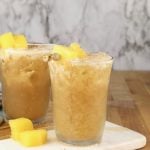 2 Painkiller cocktails with pineapple garnish