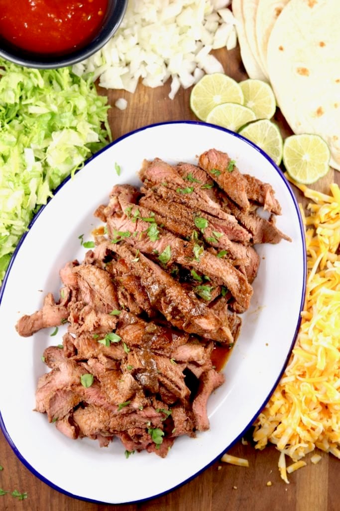 Carne Asada platter with taco toppings