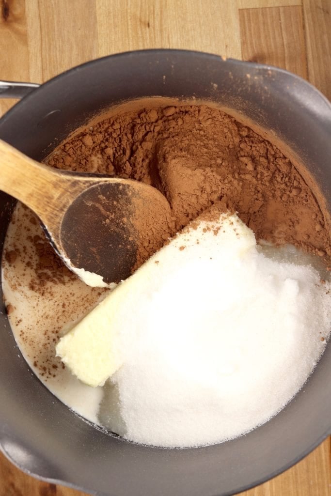 Pan with milk, butter, sugar and cocoa powder for no bake cookies