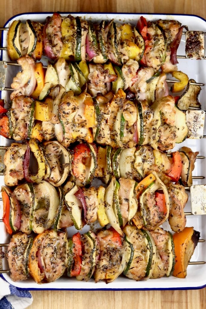 Grilled Chicken and vegetable kebabs on a white enamel tray