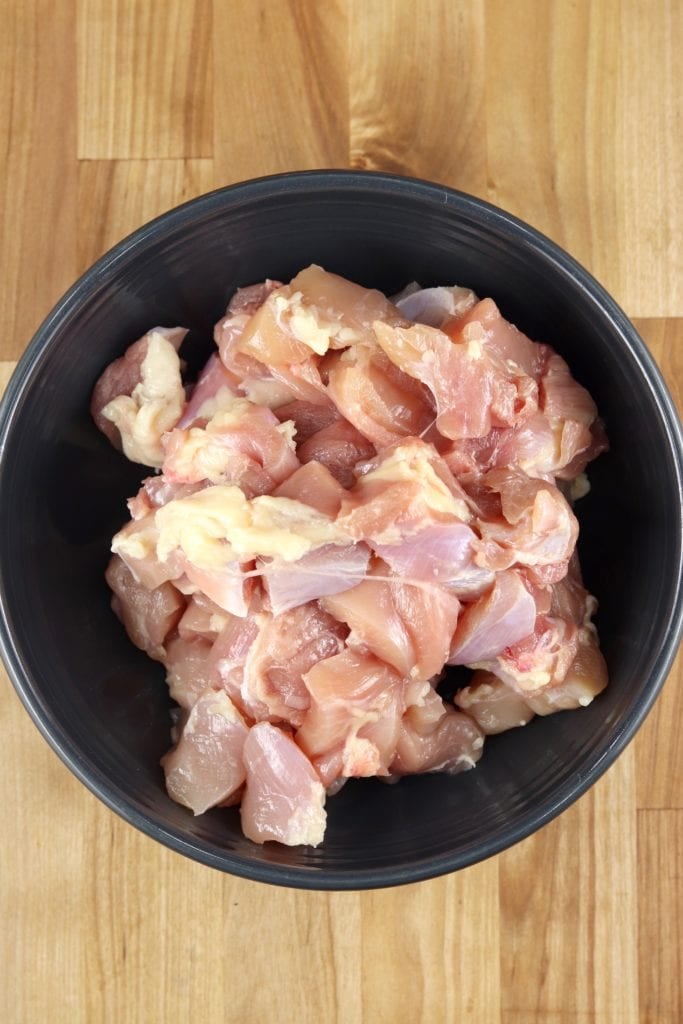 Diced chicken breasts in a bowl for grilling