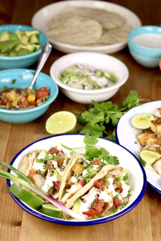 Grilled fish tacos with lime crema, salsa and cilantro