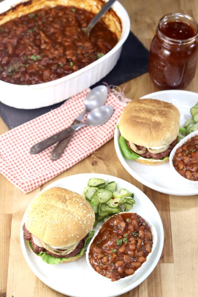 2 Plates of burgers, baked beans, cucumber salad