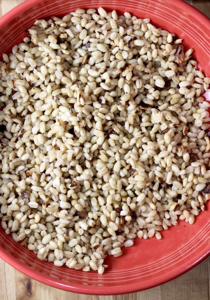Cooked pearl barley in a red bowl