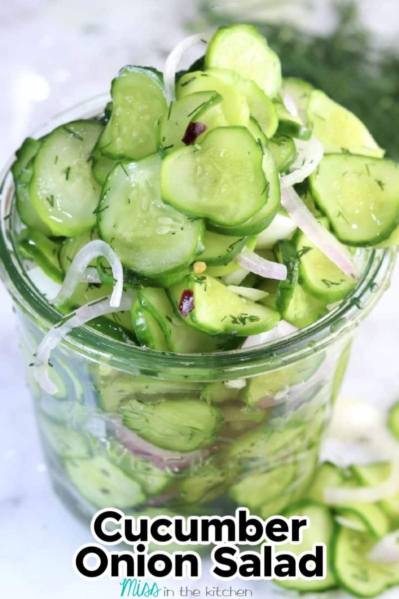 Glass jar of cucumber onion salad. Text overlay.