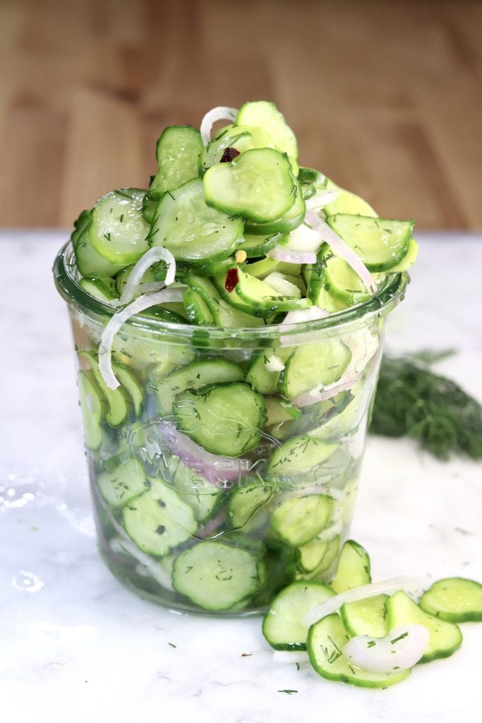 Cucumber Onion Salad in a jar on a white board
