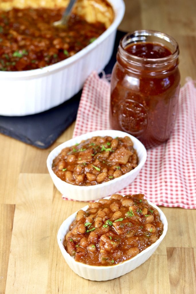 Baked Beans in 2 serving dishes, jar of bbq sauce