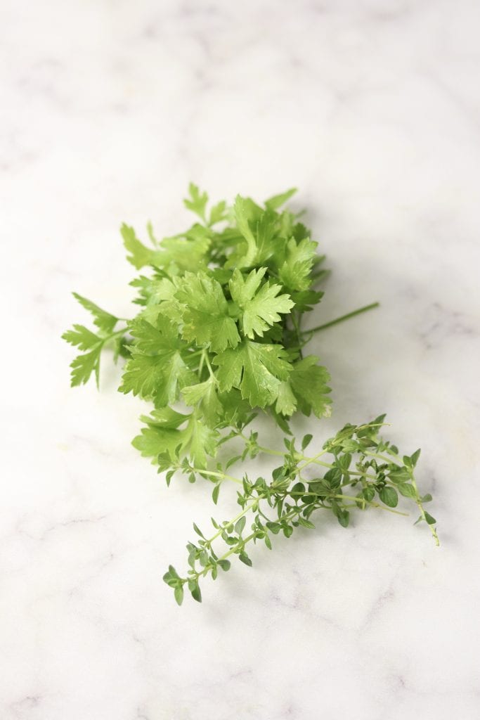 Fresh parsley and thyme on a marble board